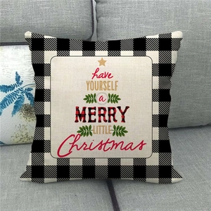 Detail of Christmas buffalo plaid pillow cover with festive tree shaped typography