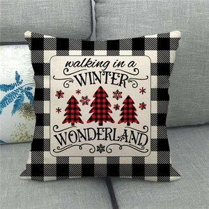 Detail of Christmas buffalo plaid linen pillow cover on a grey fabric sofa