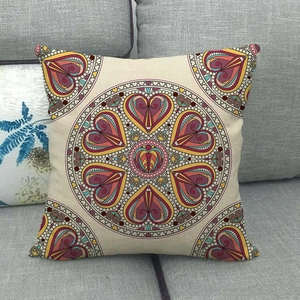 Bohemian linen pillowcase featuring a colorful mandala heart pattern on a grey sofa