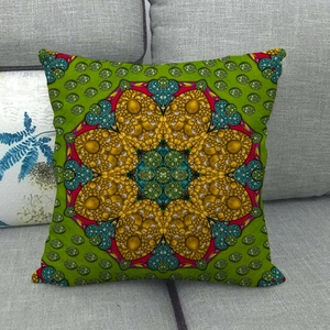 Detailed close-up of emerald green linen pillowcase with golden mandala pattern