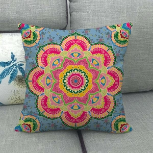 Bohemian linen pillow cover with vibrant mandala floral pattern on a grey sofa