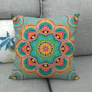 Detail of bohemian mandala pattern linen pillowcase on a grey fabric sofa
