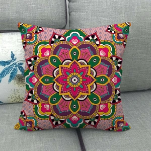 Close-up of bohemian linen pillowcase with colorful mandala floral patterns on a gray sofa