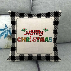 Close-up of linen Christmas pillow case with buffalo plaid and festive art text