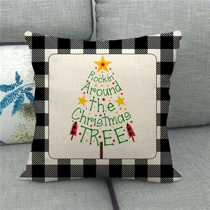 Detail of linen Christmas pillow cover with buffalo plaid border and tree text design