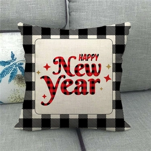 Beige linen Happy New Year pillow cover with black and white plaid border on a sofa