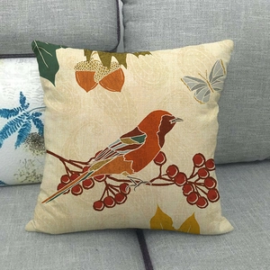 Detail of autumn pillow case featuring orange bird and acorn print on linen texture fabric
