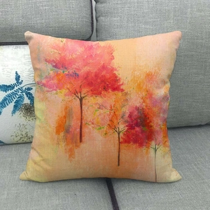 Detail of autumn maple tree pattern on linen pillow cover showing fabric texture
