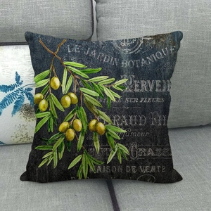 Vintage botanical linen pillowcase with olive branch print on a cozy grey sofa