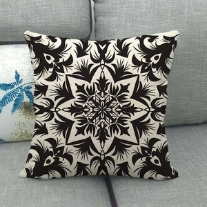 Bohemian linen pillow cover with black geometric mandala print on beige sofa background