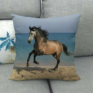 Running horse oil painting pillow case on a grey sofa with coastal beach print