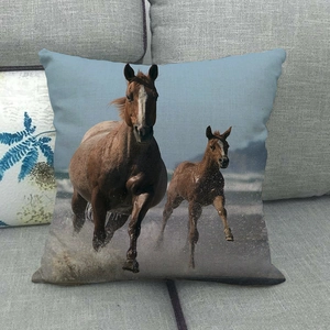 Detailed close-up of a linen pillowcase featuring two running horses on a beach scene