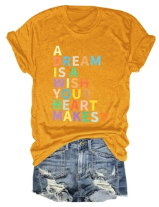 Flat lay of yellow t-shirt with colorful text and distressed denim shorts on white background