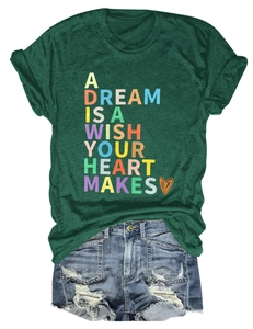 Flat lay of green t-shirt with artistic quote and distressed denim shorts on white background