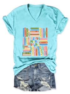 Flat lay of cyan V-neck T-shirt with Read More Books print and distressed denim shorts