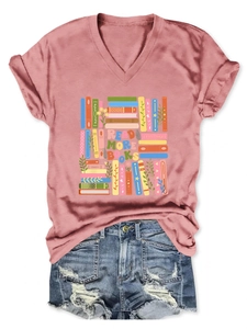 Flat lay of pink V-neck T-shirt with Read More Books graphic and denim shorts