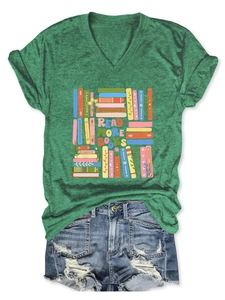 Flat lay of a green V-neck T-shirt with 'READ MORE BOOKS' print and ripped denim shorts