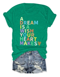 Detail of green T-shirt with 'A Dream' slogan and distressed blue denim shorts set