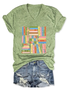 Flat lay of a green V-neck t-shirt with Read More Books print and ripped denim shorts