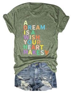 Close-up of army green t-shirt with artistic text and distressed denim shorts
