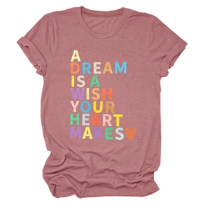 Close-up of colorful lettering and orange heart print on pink short sleeve t-shirt