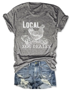 Flat lay of heather grey t-shirt with local egg dealer print and distressed denim shorts
