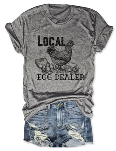 Flat lay detail of grey Local Egg Dealer vintage t-shirt and distressed denim shorts
