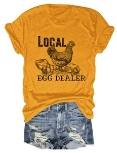 Detail of Local Egg Dealer print on ginger yellow t-shirt and distressed denim shorts