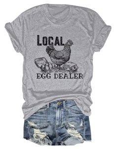 Flat lay detail of grey cotton t-shirt featuring local egg dealer graphic and denim shorts