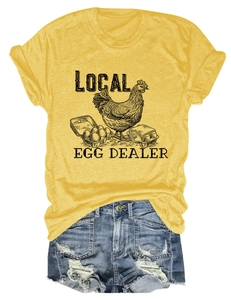 Flat lay of yellow cotton T-shirt with local egg dealer print and denim shorts