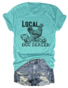 Flat lay of a mint green t-shirt with local egg dealer print and denim shorts
