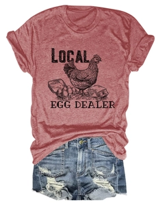 Close-up of vintage hen and egg dealer print on brick red cotton t-shirt fabric