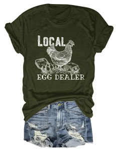 Close-up of olive green t-shirt with white Local Egg Dealer print and denim shorts
