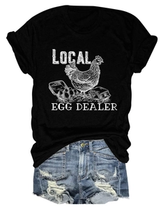 Flat lay of Local Egg Dealer black t-shirt with distressed denim shorts on white background