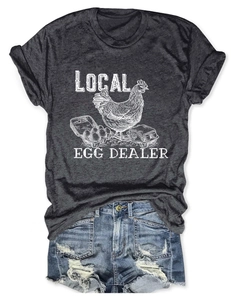 Flat lay of dark gray T-shirt with local egg dealer print and denim shorts
