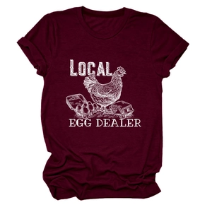 Close-up of Local Egg Dealer white graphic print on a burgundy cotton t-shirt fabric