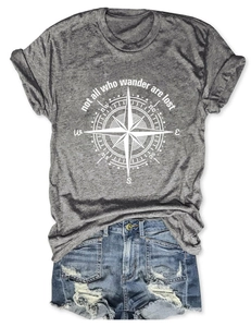 Detailed flat lay of a grey t-shirt with a compass print and distressed denim shorts