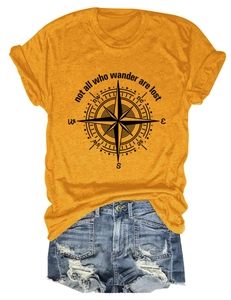 Flat lay of mustard yellow compass t-shirt and distressed denim shorts casual outfit