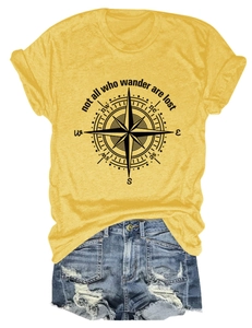 Detailed view of yellow T-shirt with compass print and distressed denim shorts