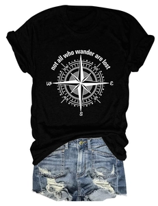 Flat lay of a black compass t-shirt with distressed blue denim shorts on white background