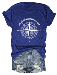 Flat lay of navy blue t-shirt with white compass print and denim shorts on white background