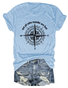 Flat lay of light blue compass t-shirt paired with distressed denim shorts on white background