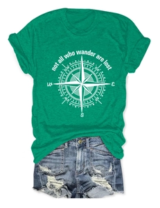 Flat lay of a green cotton T-shirt with compass print and 'not all who wander' quote