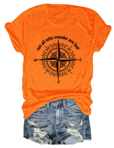 Close-up of orange t-shirt with compass print and not all who wander are lost slogan