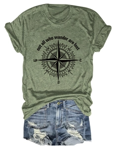 Detailed flat lay of army green graphic t-shirt with compass print and frayed denim shorts