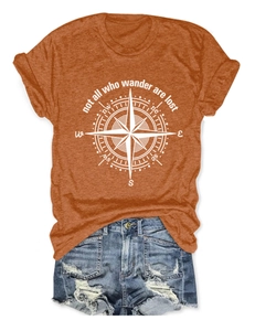Detail of burnt orange t-shirt with compass print and not all who wander are lost text