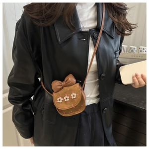 Girl's brown mini PU crossbody bag with large bow and 3D floral details on flap