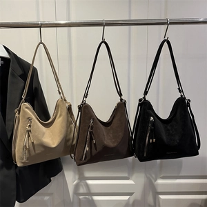 Three large fashion tote bags in khaki, brown and black with decorative side tassels