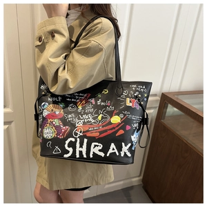 Detail of black pebbled leather bucket bag featuring colorful graffiti and bear prints