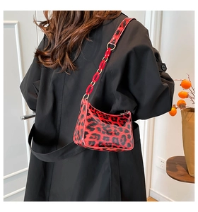 Detail view of red and black leopard print shiny shoulder bag with thick acrylic chain